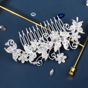 Detailed close-up of bridal hair comb with shimmering rhinestones and floral leaf design