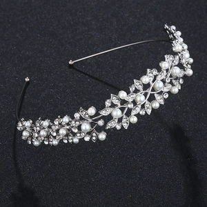 Elegant silver bridal headband with sparkling rhinestones and white pearls for wedding
