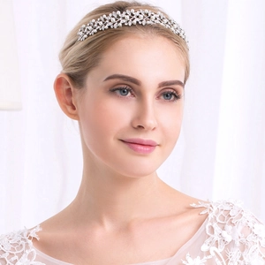 Elegant bridal headband featuring white pearls and crystals with leaf design for weddings