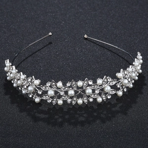 Close-up of elegant bridal headband with white pearls and sparkling crystal leaves