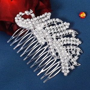 Detail of silver peacock hair comb with rhinestones for bridal wedding hairstyles