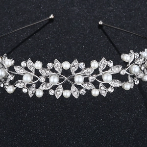 Close-up of silver bridal headband featuring intricate white pearls and sparkling rhinestones