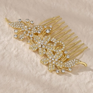 Detailed view of bridal hair comb with gold alloy floral leaves and sparkling crystals