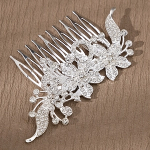 Close-up of bridal hair comb with silver flower details and crystal rhinestone inlay