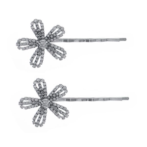 Close-up of two silver floral hair pins with sparkling rhinestones on a white background