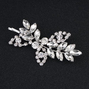 Macro view of crystal rhinestone hair clip with silver alloy leaf and floral patterns