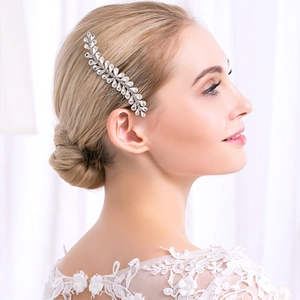 Elegant silver leaf hair comb with crystals worn by a bride with golden hair
