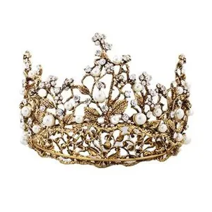 Macro shot of Baroque bridal crown with gold alloy finish and white pearl inlay