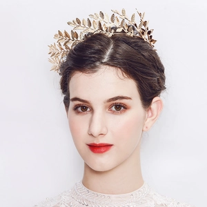 Detailed view of elegant gold olive leaf bridal crown with intricate hollow metal textures