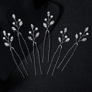 Detail of 6 handmade U-shaped hair pins with crystals and white pearls for bridal styling
