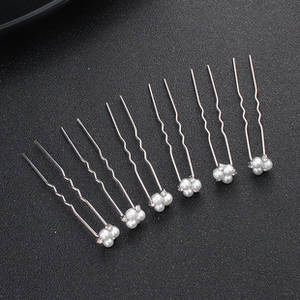 Detail view of 6-piece silver U-shaped hair pins with white pearls and small rhinestones