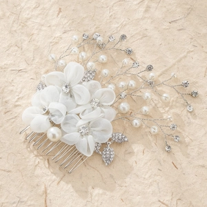 Elegant silver bridal hair comb with white fabric flowers, pearls, and rhinestones