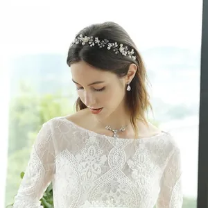 Close-up of handmade bridal headband set with pearls, rhinestones and matching earrings