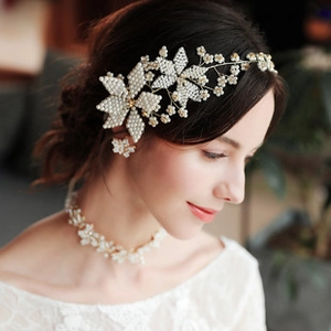 Detail of bridal jewelry set with white pearls and rhinestones on a female model