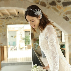 Detail showing bridal flower headband with silver alloy leaves and white crystals in hair