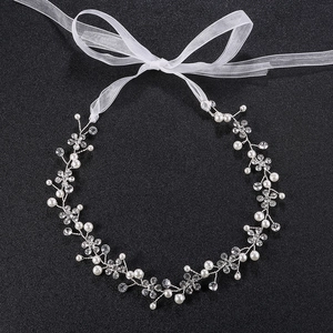 Detail of handmade bridal headband with silver wire, pearls and sparkling rhinestones