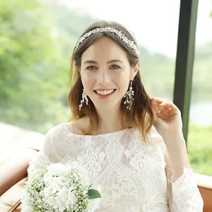 Elegant bridal headpiece and earring set with pearls and rhinestones on a wedding model