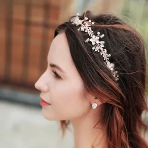 Macro shot of rose gold bridal headband with delicate pearls and floral crystals