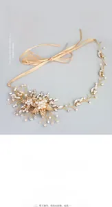 Macro detail of handmade bridal headband with gold alloy leaves, pearls and crystals