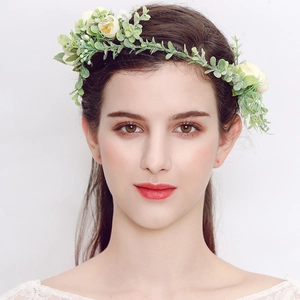 Floral bridal headpiece with white and yellow faux flowers and green leaves for photography