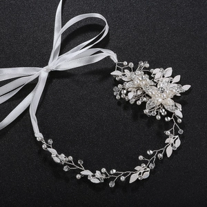 Handmade bridal headband with silver leaf accents, pearls and crystals on dark grey background