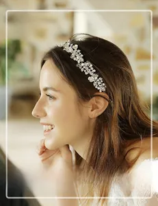 Detail view of crystal leaves and pearls on a bridal headband worn by a bride