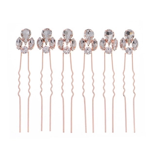 Detail of six rose gold U-shaped hair pins with sparkling rhinestone crown tops