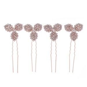 Detail of four rose gold bridal hair pins with rhinestone clover design and pearls