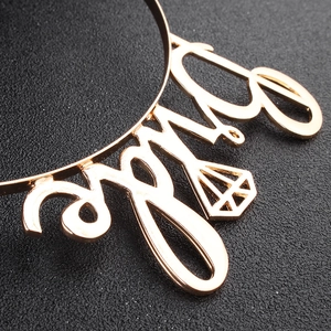 Close-up of golden alloy Bride headband featuring artistic script and hollow diamond frame