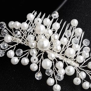 Close-up of handmade bridal hair comb with pearls and crystals on silver wire