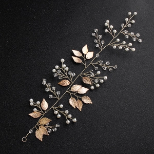 Vintage bridal headband with gold leaves, white pearls and crystals on black background