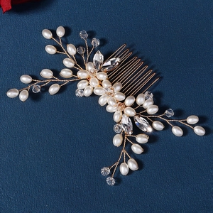 Macro shot of handmade bridal hair comb with pearls and crystals on gold wire