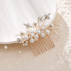 Detail view of handmade gold bridal hair comb with elegant pearls and crystal accents