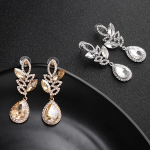 Detail view of luxury marquise crystal drop earrings in gold and silver finishes