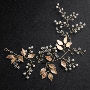 Detail of handmade gold hair vine with white pearls and crystals for bridal hair