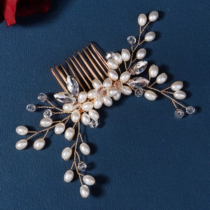 Close-up of handmade bridal hair comb with elegant pearls and sparkling crystals