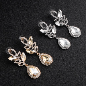 Close-up of luxury marquise crystal earrings in silver and champagne gold finishes
