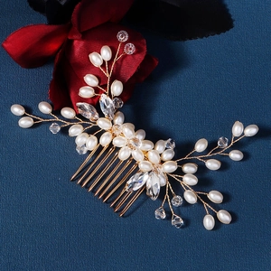 Close-up of handmade bridal hair comb with pearls and crystals on gold wire