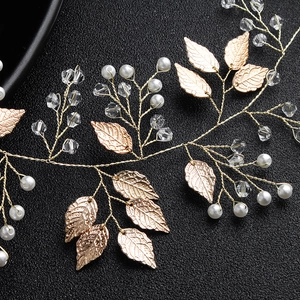 Handmade gold bridal hair vine with delicate metal leaves, white pearls and clear crystals
