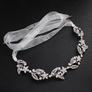Detailed view of bridal headband with silver alloy flowers and rhinestone pavé settings