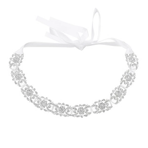 Macro detail of bridal hairband with crystal leaf clusters and white satin ribbon ties