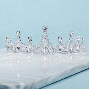 Elegant silver Baroque bridal crown with sparkling rhinestones on marble surface