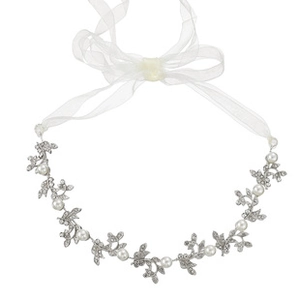 Detailed macro shot of bridal headband featuring silver alloy leaves and white faux pearls