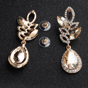 Detailed view of champagne crystal teardrop earrings with golden plating and back details