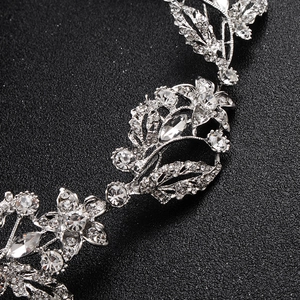 Macro shot of silver bridal headband featuring intricate crystal flower and leaf details