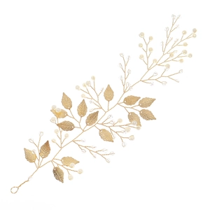 Elegant bridal hair vine with golden metal leaves and white pearls for wedding hairstyles