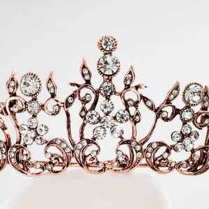 Macro view of vintage bronze alloy bridal crown with floral patterns and inlaid rhinestones