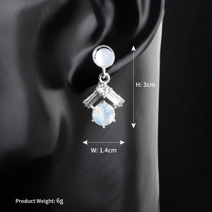 Detail of luxury bridal drop earrings with opal stones and zircon crystals on model