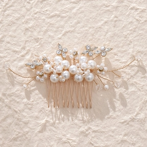 Detailed close-up of bridal hair comb with elegant white pearls and sparkling rhinestones