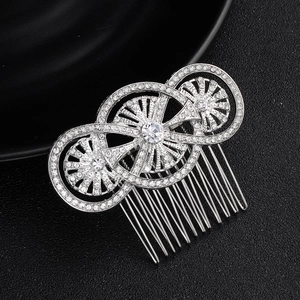 Detailed close-up of retro silver wedding hair comb with sparkling rhinestones and metal teeth